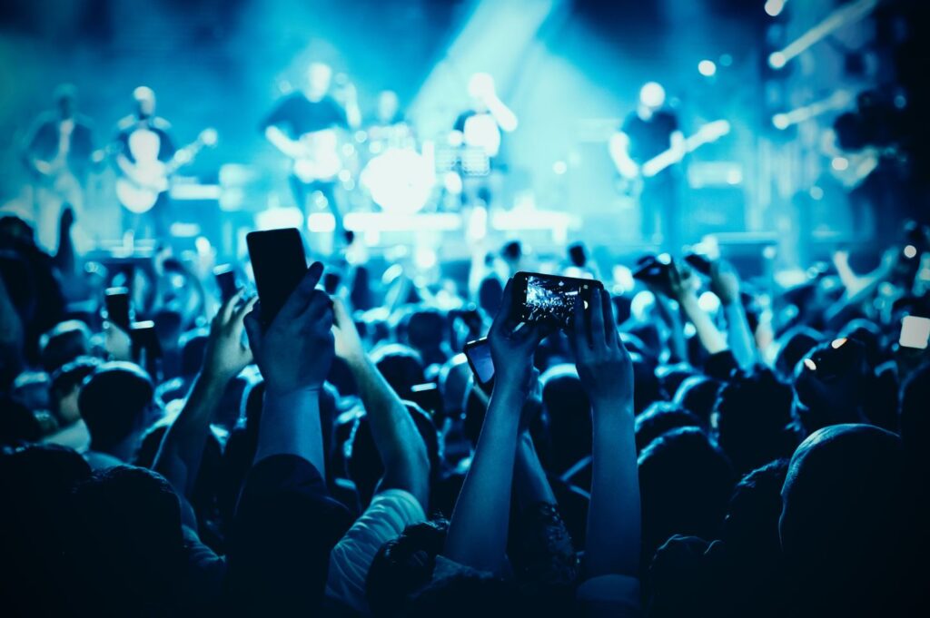 Audience-members-using-their-phones-to-take-videos-of-a-concert-1024x681